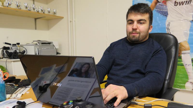 Bild på Haydar Gürbüz framför datorn.